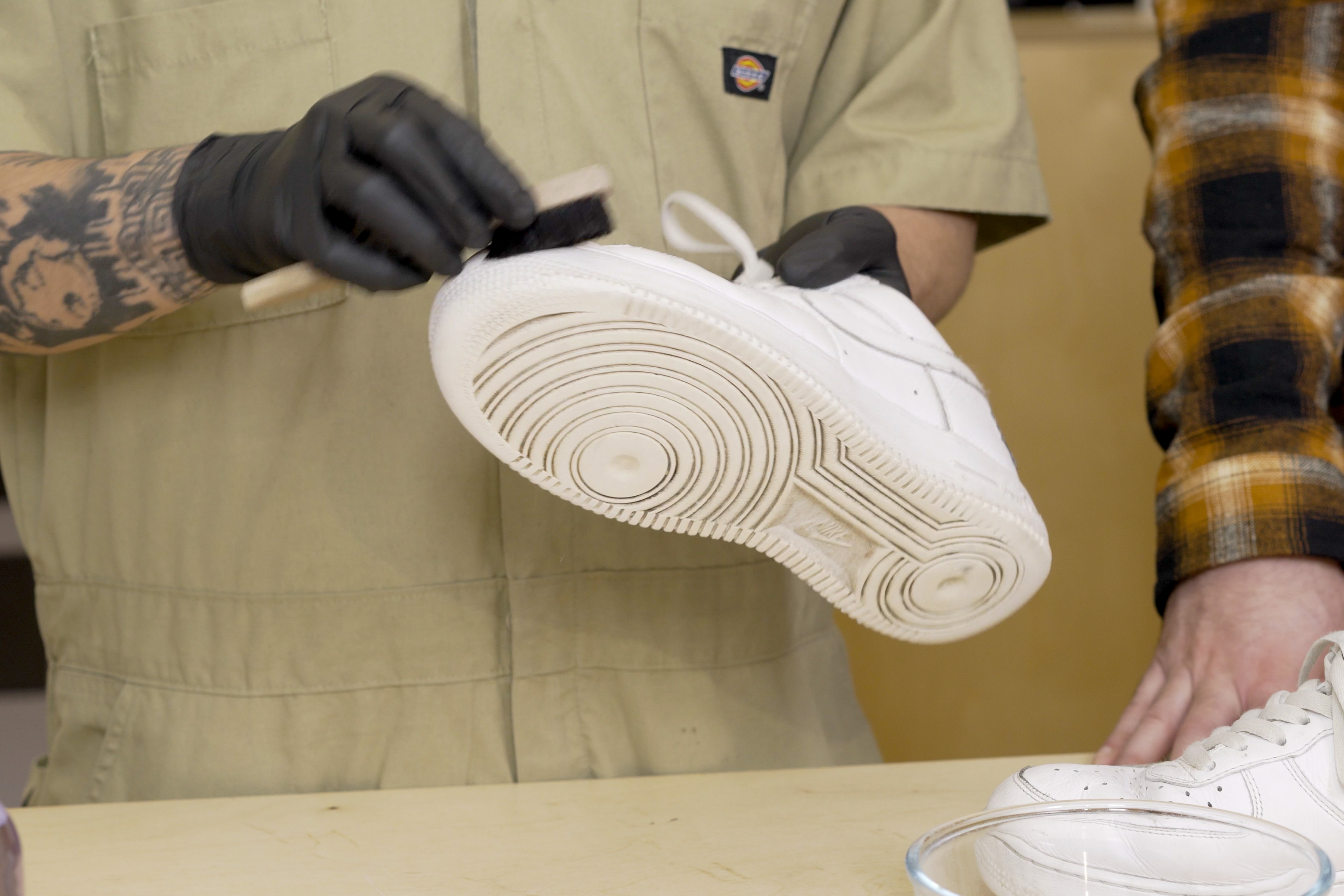 Brushing dirt off a shoe with a Jason Markk Drybrush